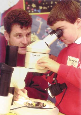 Scientist working with pupil