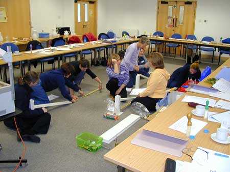teachers assembling friction ramps
