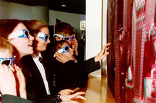 children viewing a large image wearing 3D-glasses